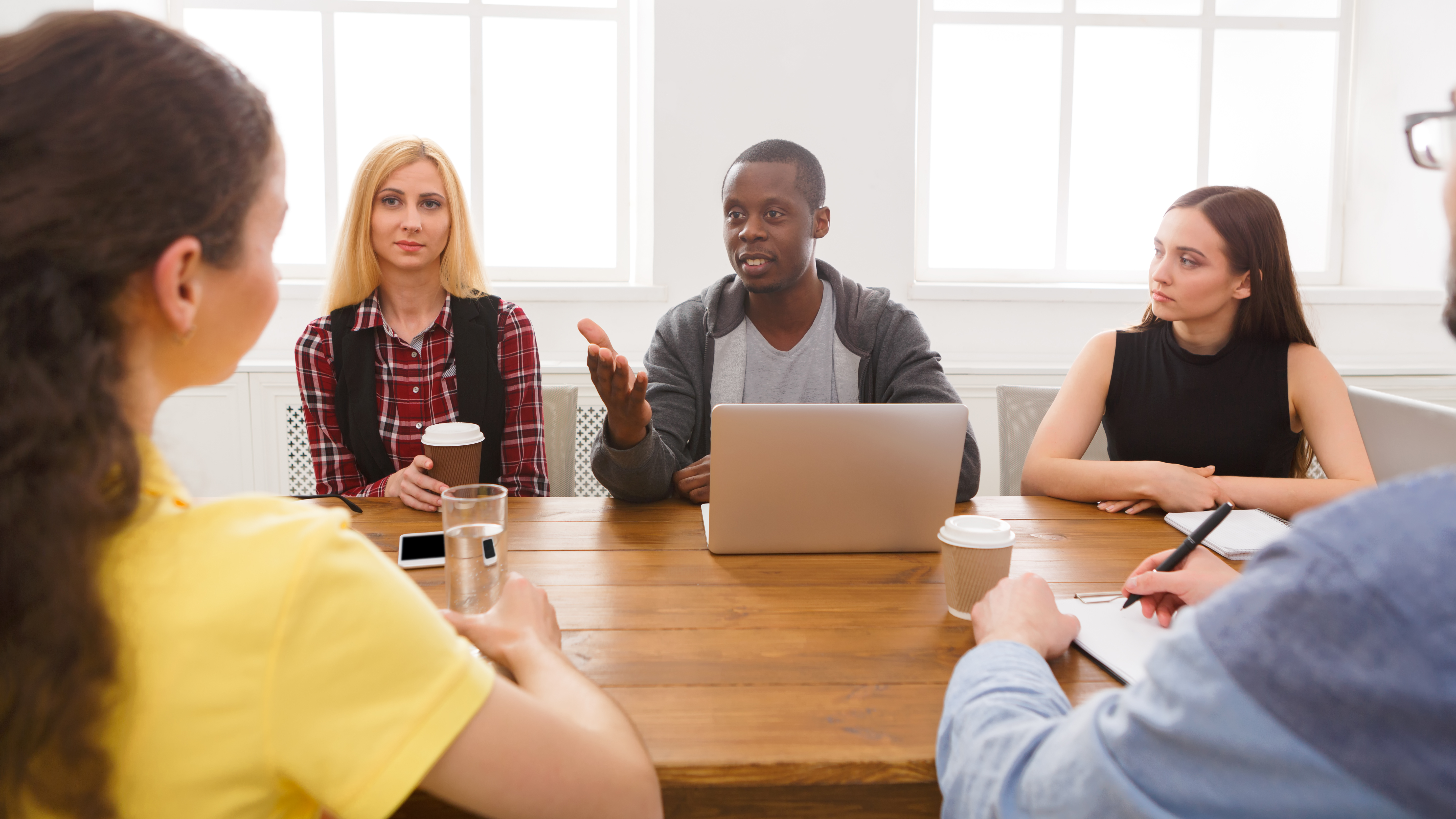 Group of People Discussing Ideas in a Meeting Room During the Af